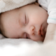 close up of a swaddled sleeping baby